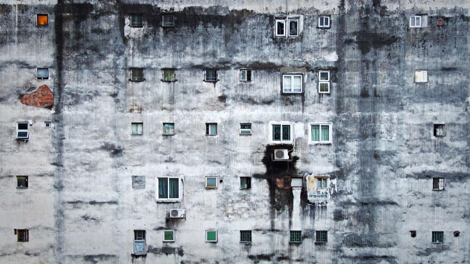 Free Image of Aged building facade with various windows and textures 