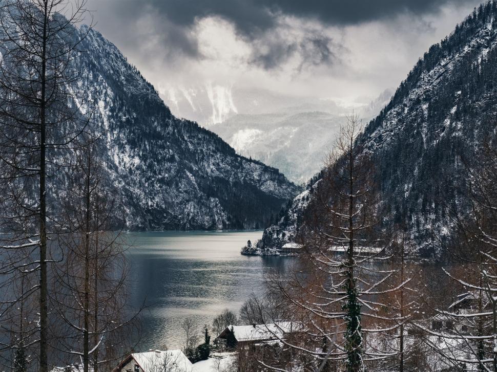 Free Image of Snowy mountains and lake with cloudy sky in the view. 