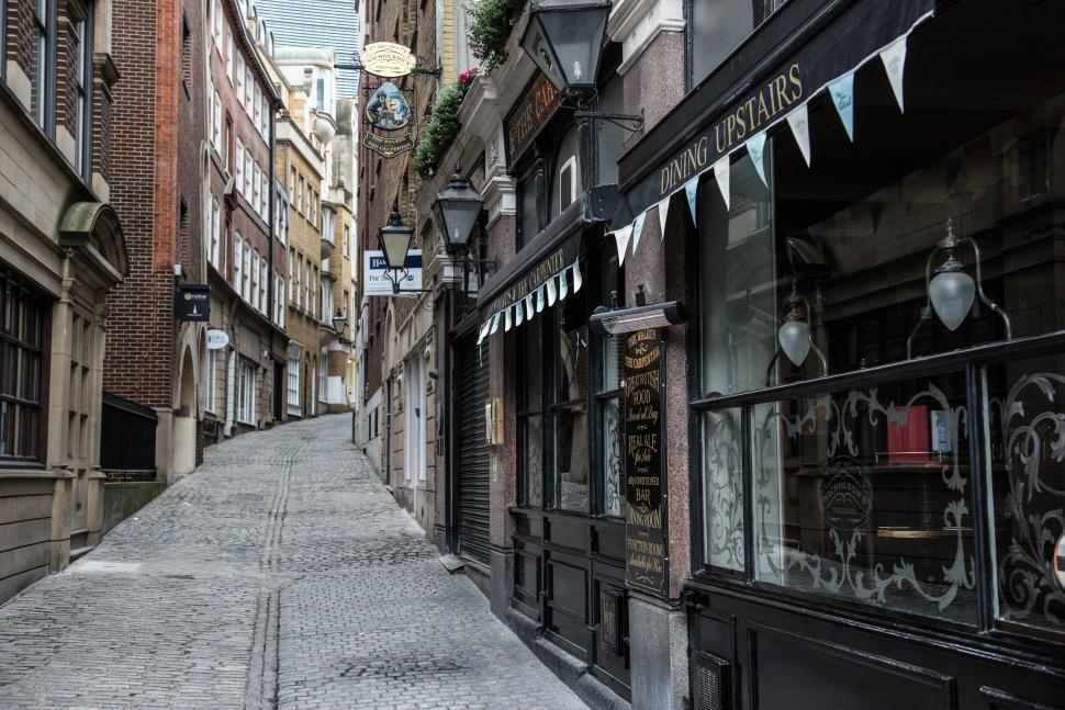 Free Image of Historical cobblestone street in modern city setting. 