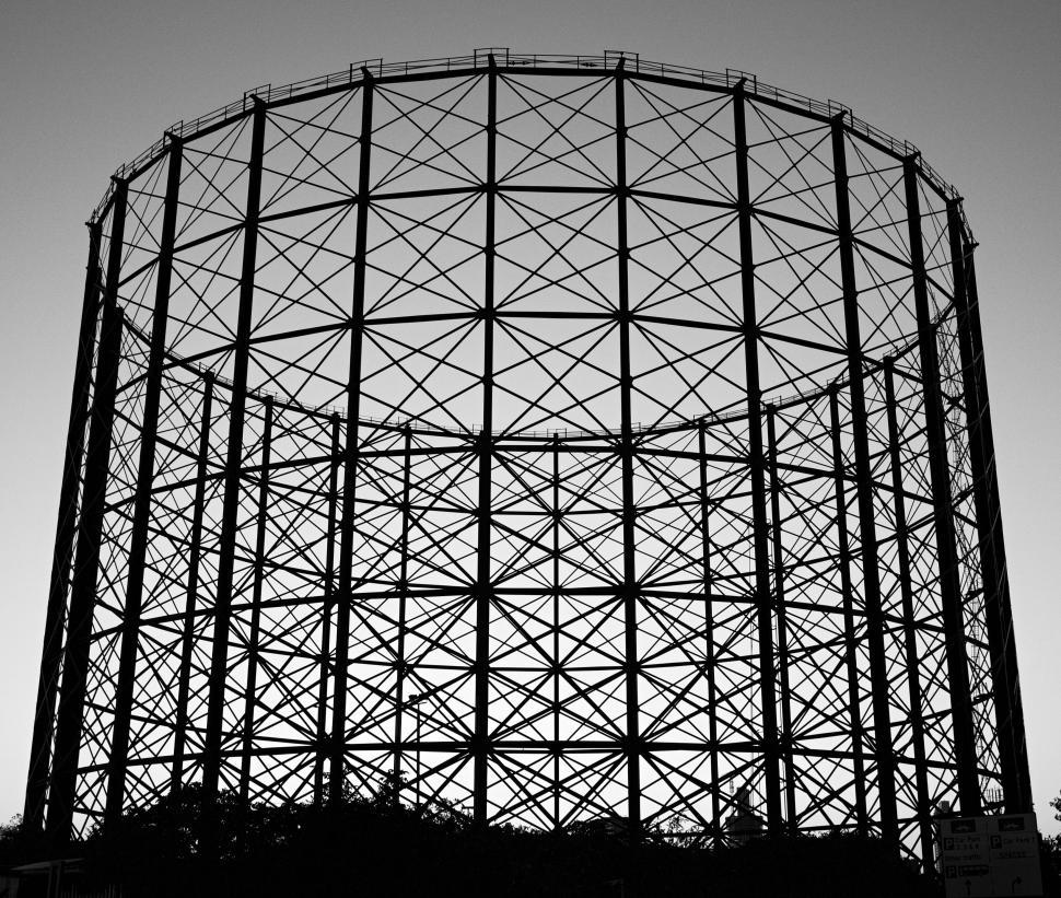 Free Image of Iron gasometer structure silhouetted against twilight sky. 