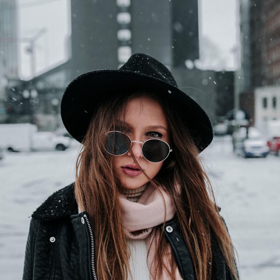 Free Image of Person in black coat and hat outside in snowy weather 