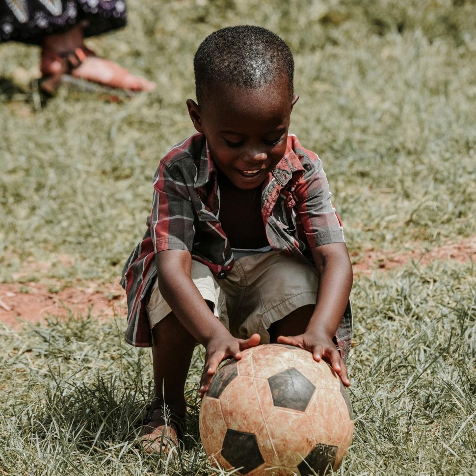 Free Image of Little child playing with a soccer ball outdoors. 