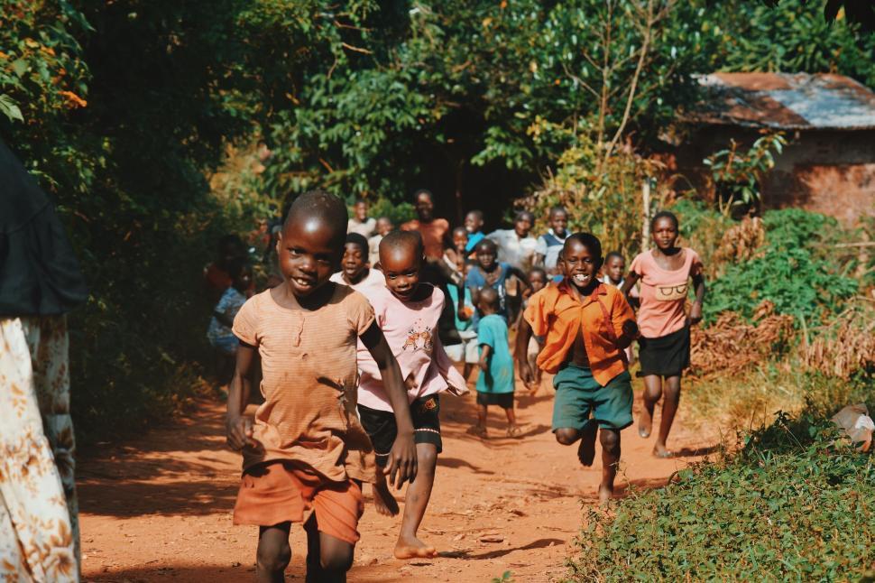 Free Image of Group of happy children running along a rural path. 