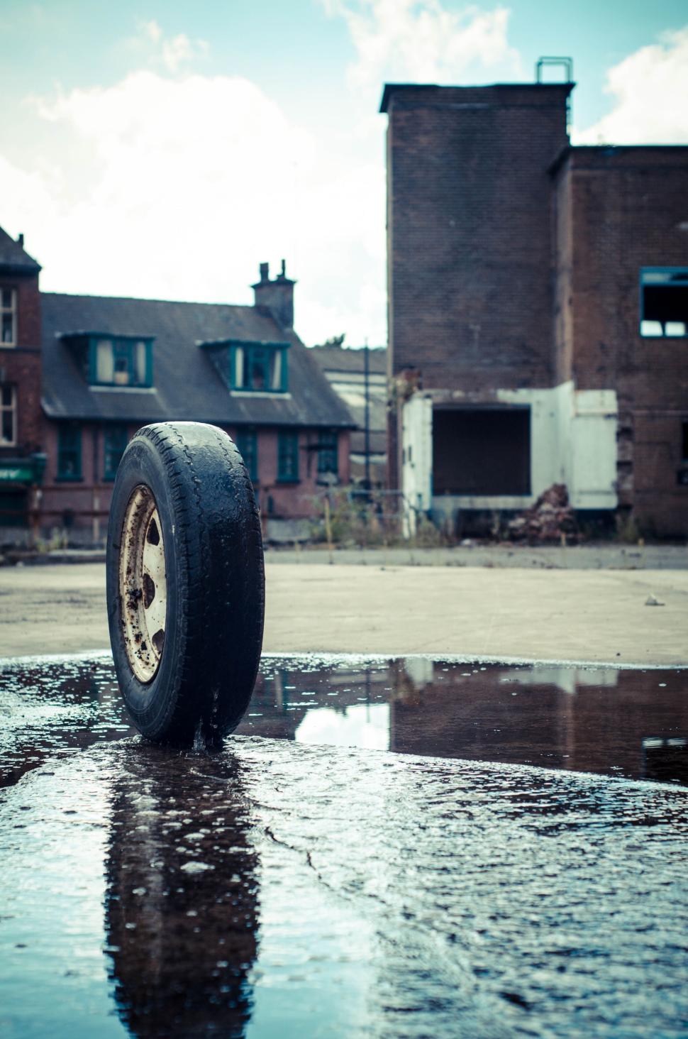 Free Image of Lonely tire in an abandoned, empty urban lot setting. 