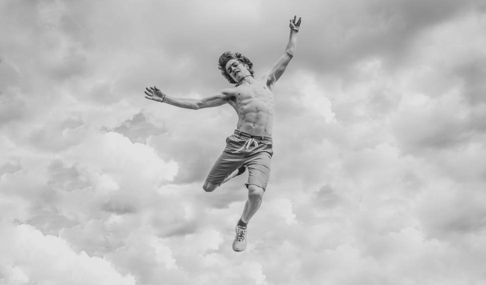 Free Image of High contrast image of a person jumping in the sky. 