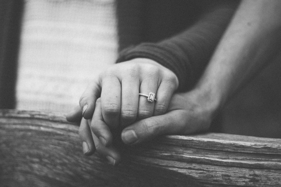 Free Image of Close-up of hands holding each other with a ring visible 