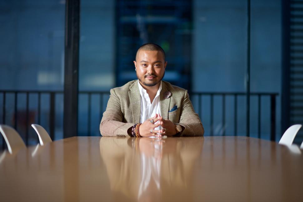Free Image of Businessman sitting confidently at a modern office table. 