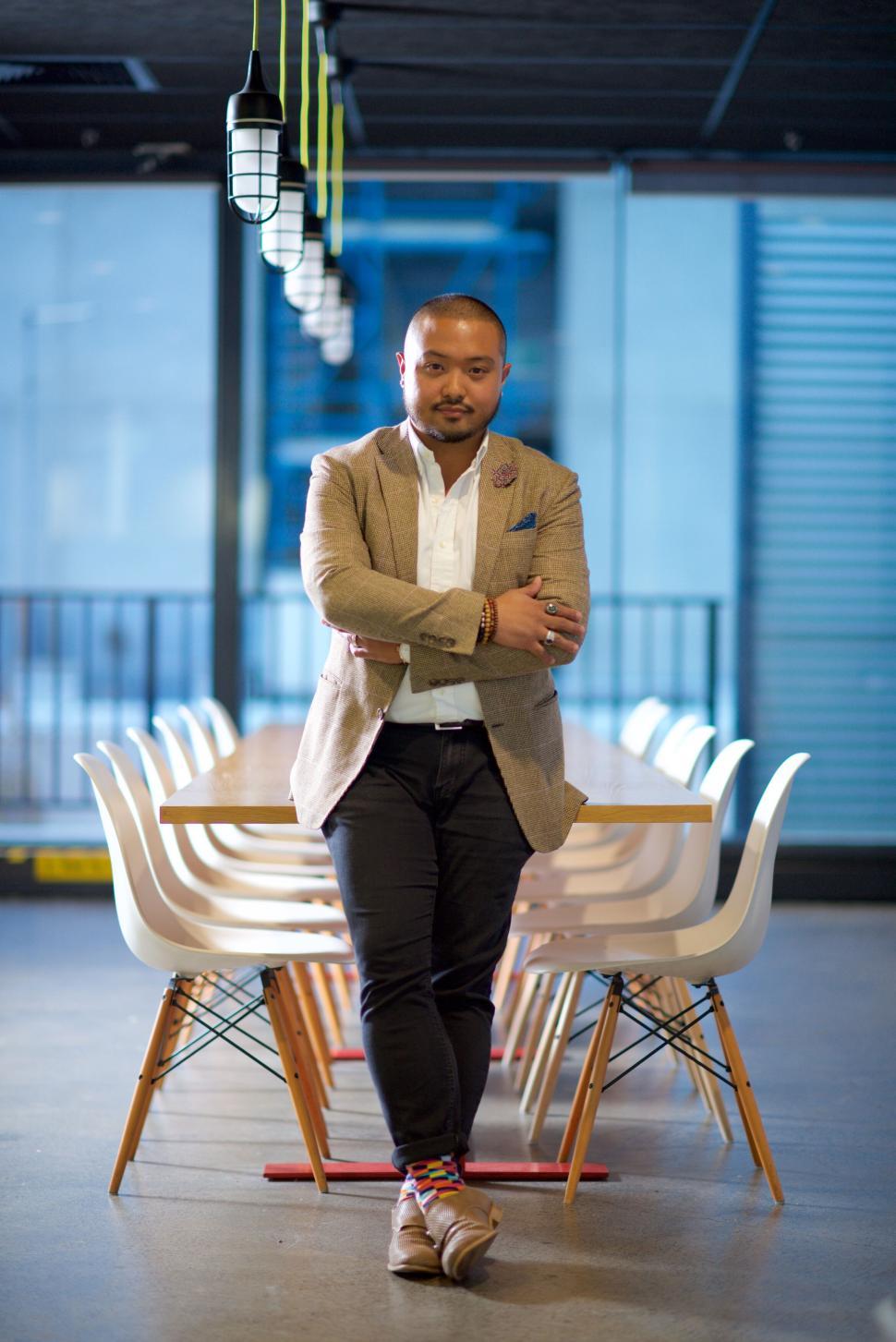 Free Image of Confident businessman standing with crossed arms in office. 