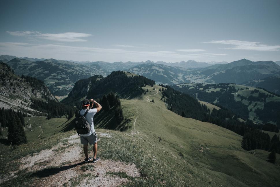 Free Image of Person photographing scenic landscape in the mountains. 