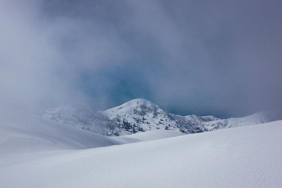 Free Image of Snow-covered mountain landscape with misty atmosphere. 