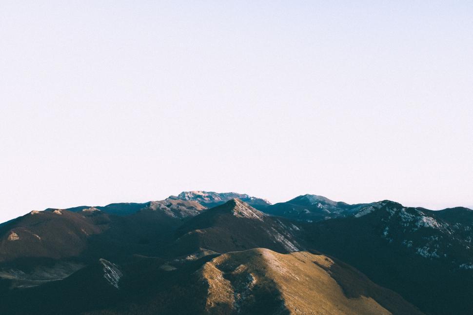 Free Image of Wide-angle view of mountain range with clear sky above 