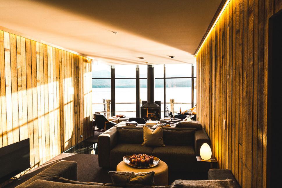 Free Image of Modern living room with wooden walls and a scenic view. 