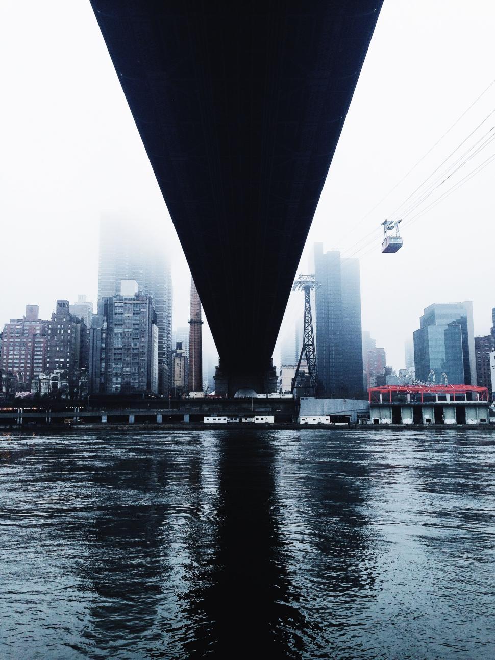 Free Image of Underneath urban bridge with cityscape in the mist 