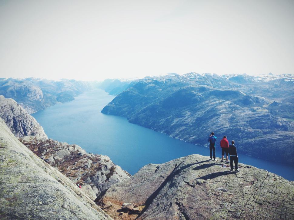Free Image of People enjoying view from high cliff above stunning fjord 