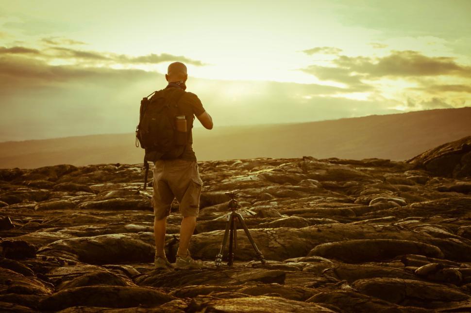 Free Image of Person setting up camera tripod in the wild outdoors 
