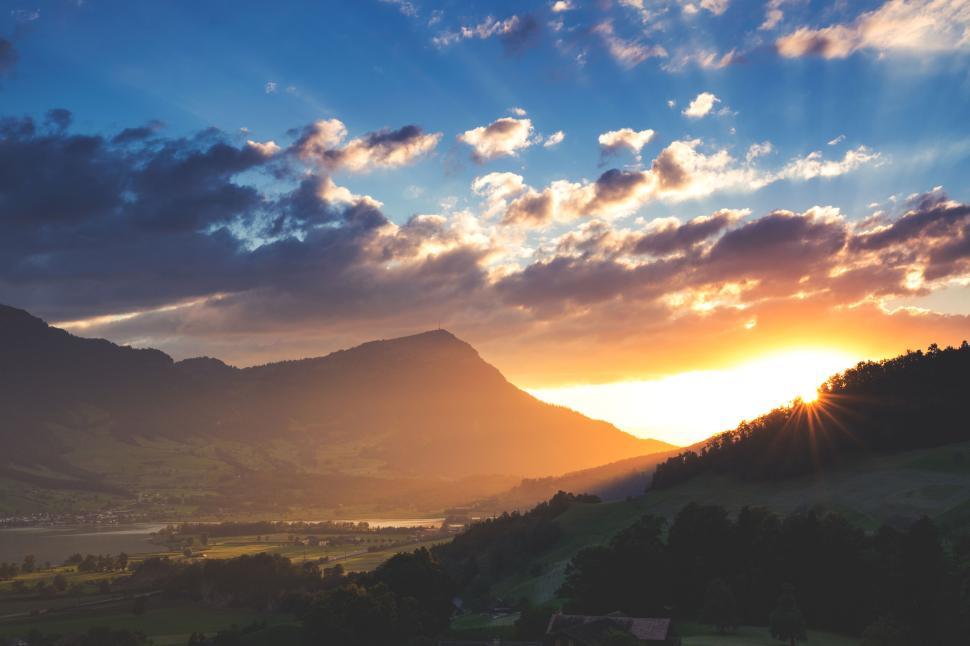 Free Image of Sunset over mountains with beautiful sky, calm moment. 