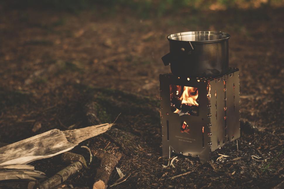 Free Image of Portable camping stove with pot in forest setting 