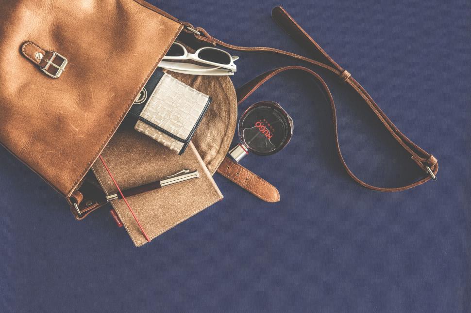 Free Image of Elegant handbag with personal items on flat surface 