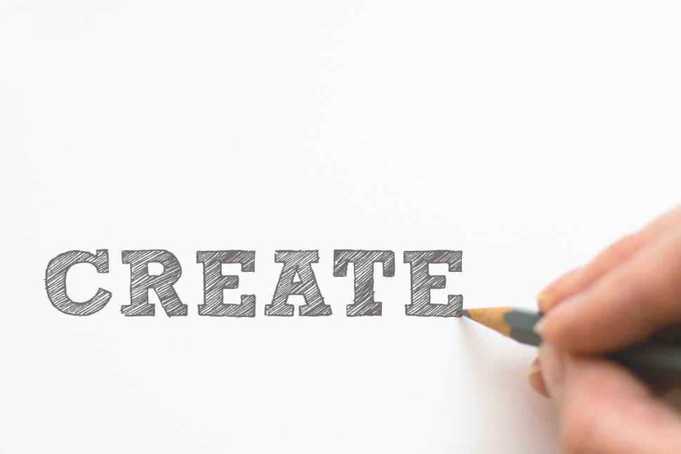 Free Image of Hand drawing CREATE on white paper with pencil 
