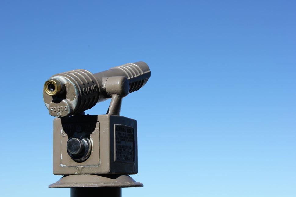 Free Image of Metal telescope viewer against clear blue sky background. 