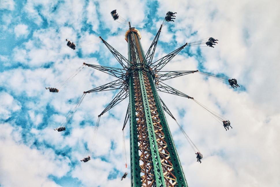 Free Image of Colorful amusement park swing ride against blue sky. 