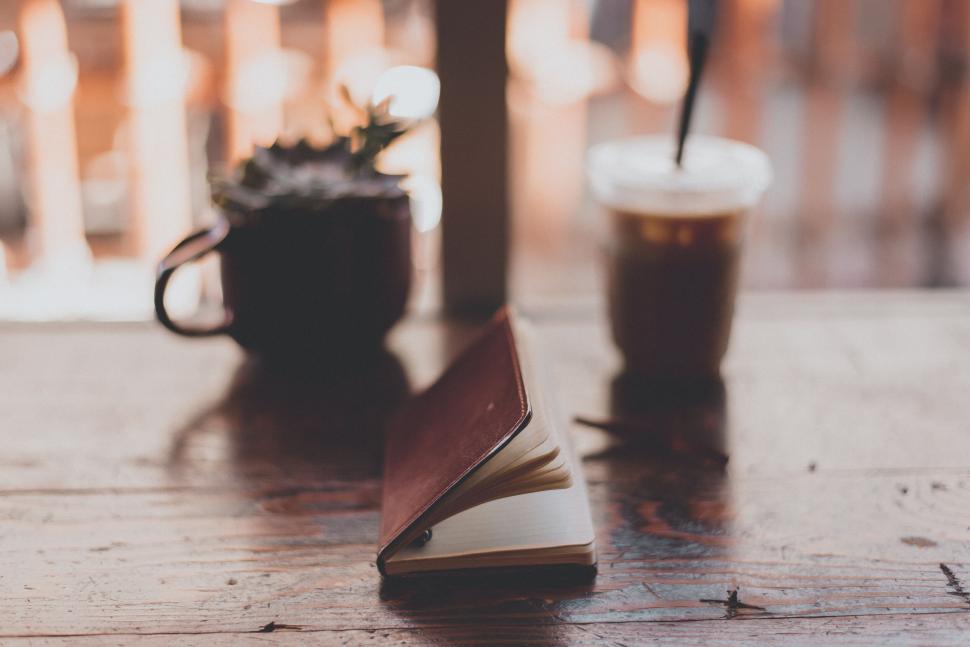 Free Image of Cozy study corner with journal and iced coffee 