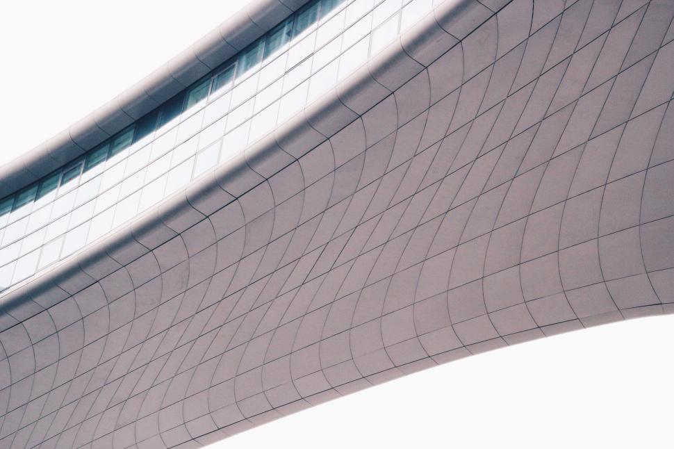 Free Image of Curved building facade with tiled design and blue windows 