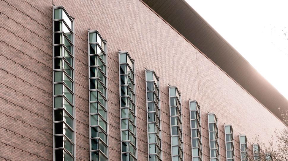 Free Image of Brick building with staggered rectangular windows design 