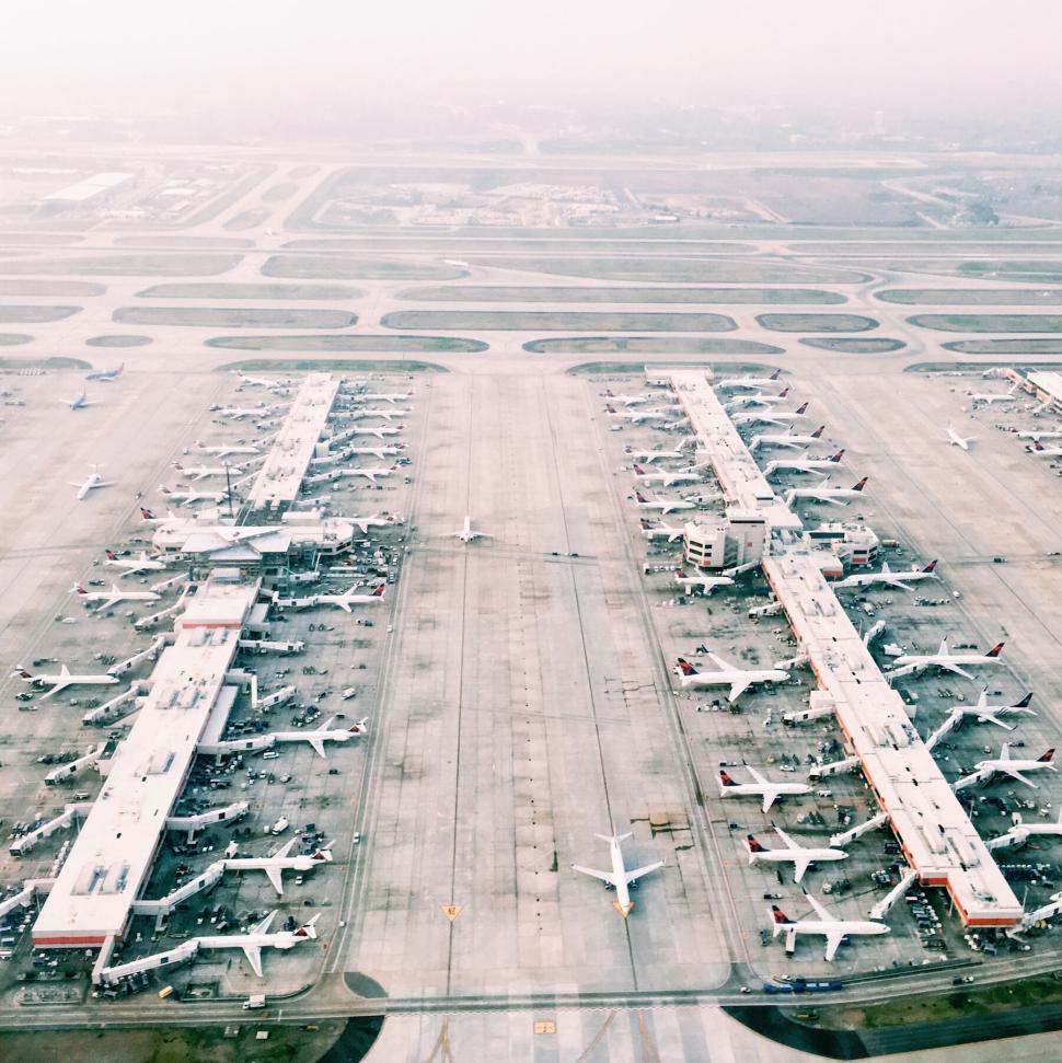 Free Image of Aerial view of busy airport with multiple terminals. 