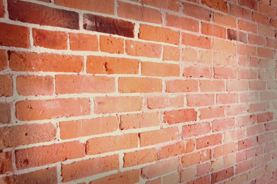 Free Image of Close-up view of textured red brick wall interior. 
