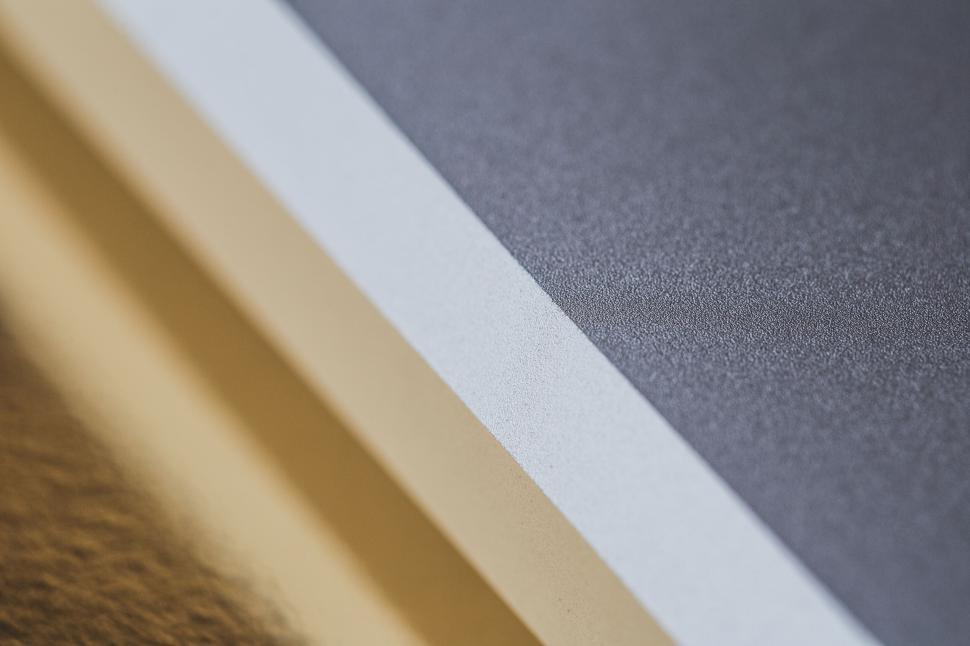 Free Image of Close-up of stacked sheets of textured paper in layers. 