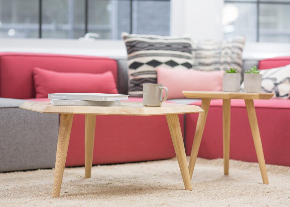 Free Image of Modern living room with wooden tables and cozy seating 