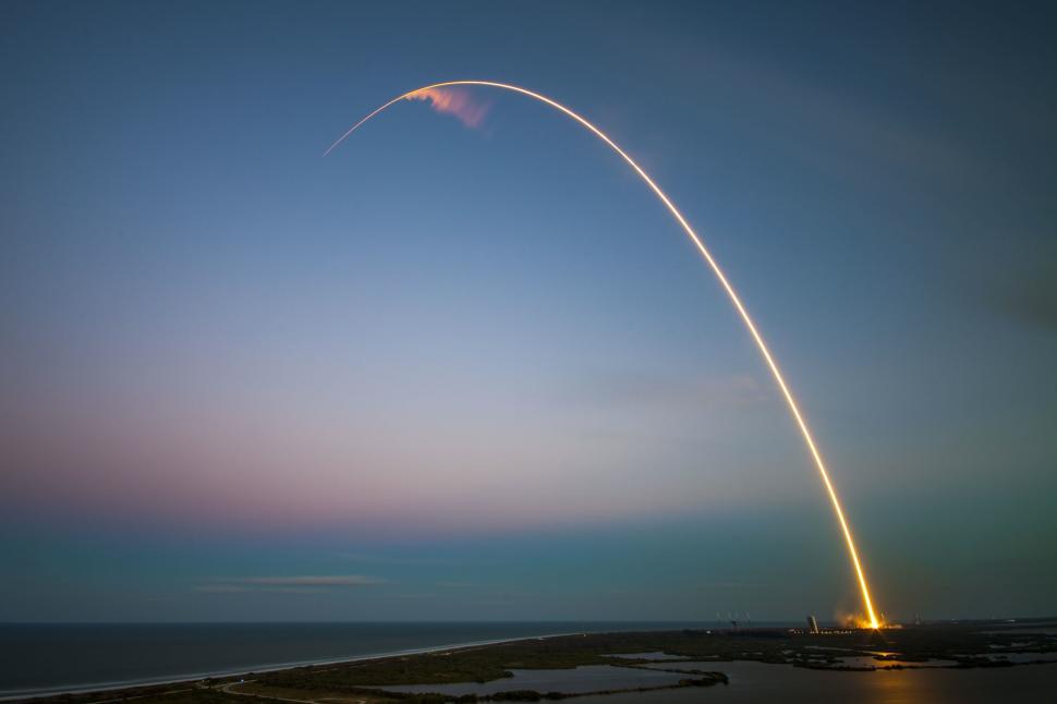 Free Image of Rocket launch creating beautiful streak in sky at dusk 