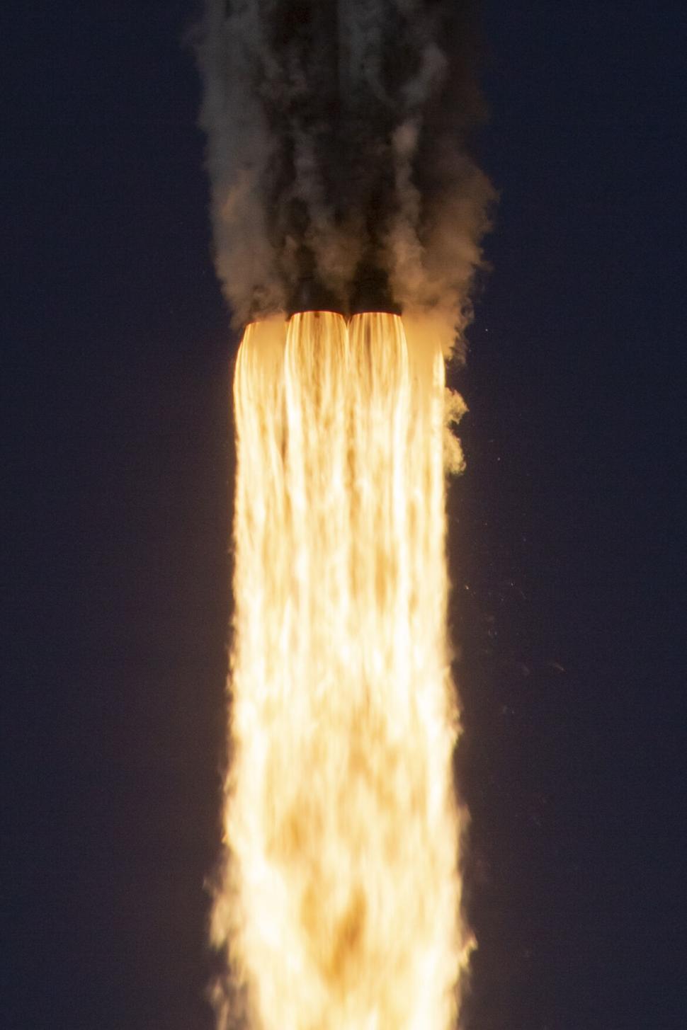 Free Image of Close-up of rocket booster flames during flight ascent 