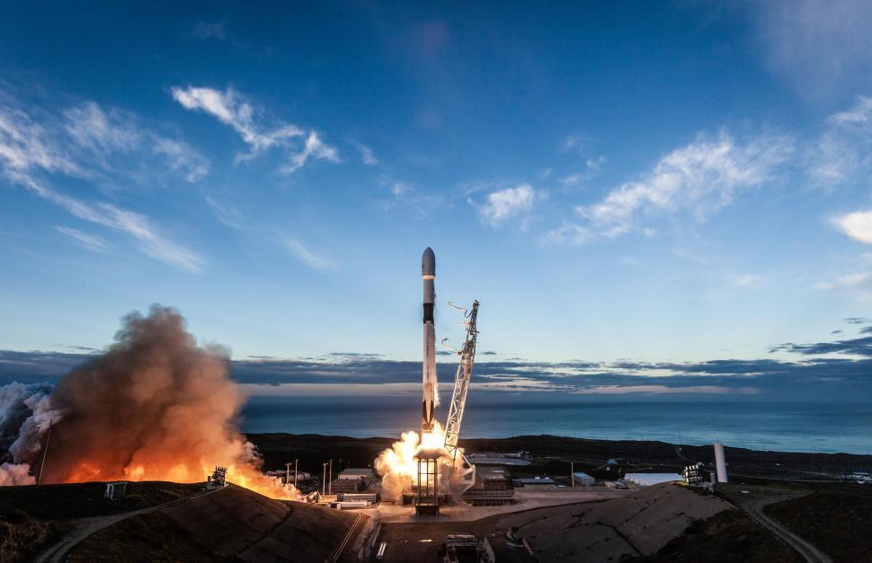 Free Image of Rocket launching from pad into sky with ignition flames 