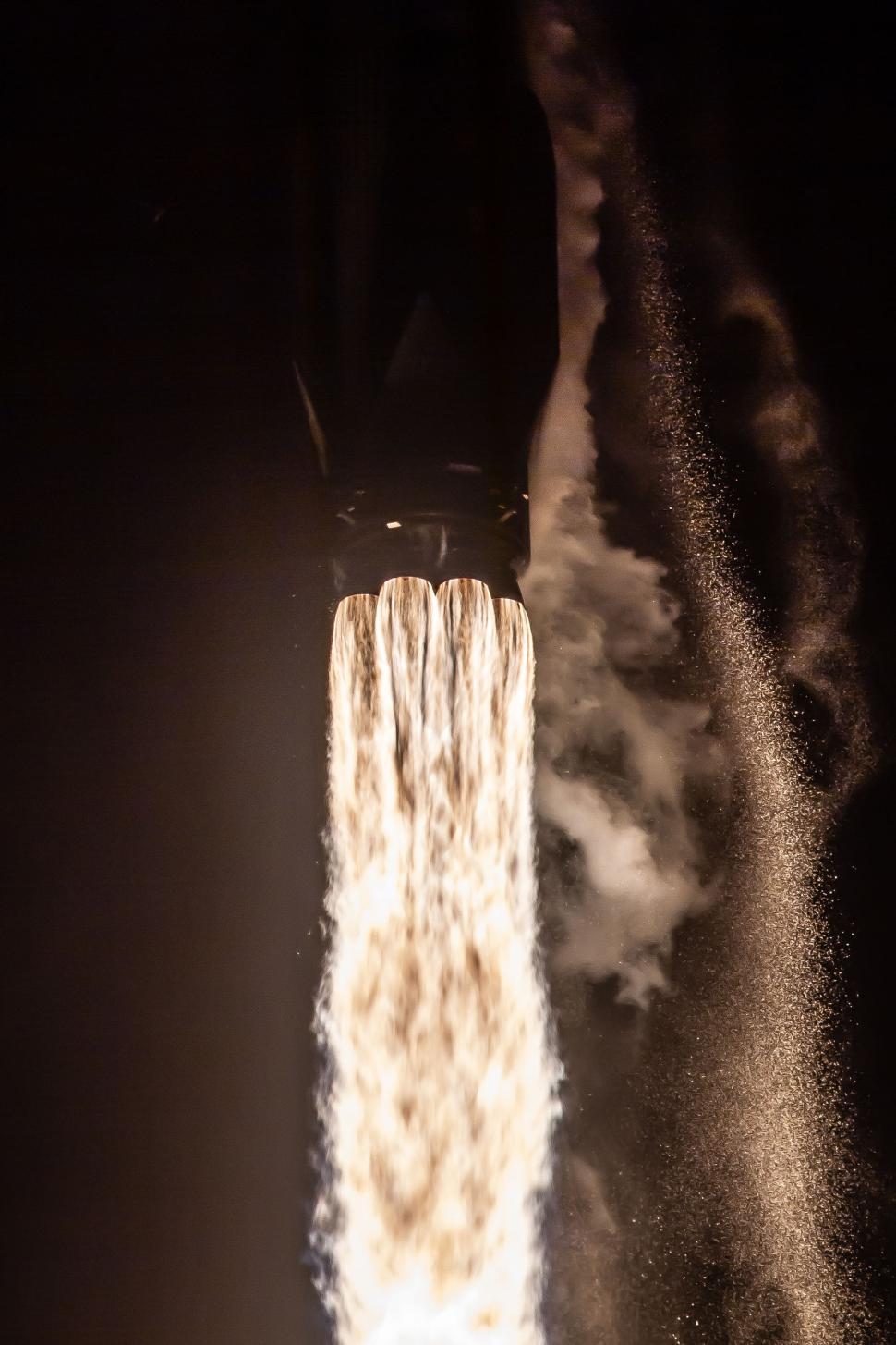 Free Image of Close-up view of rocket engine flames during night ascent 