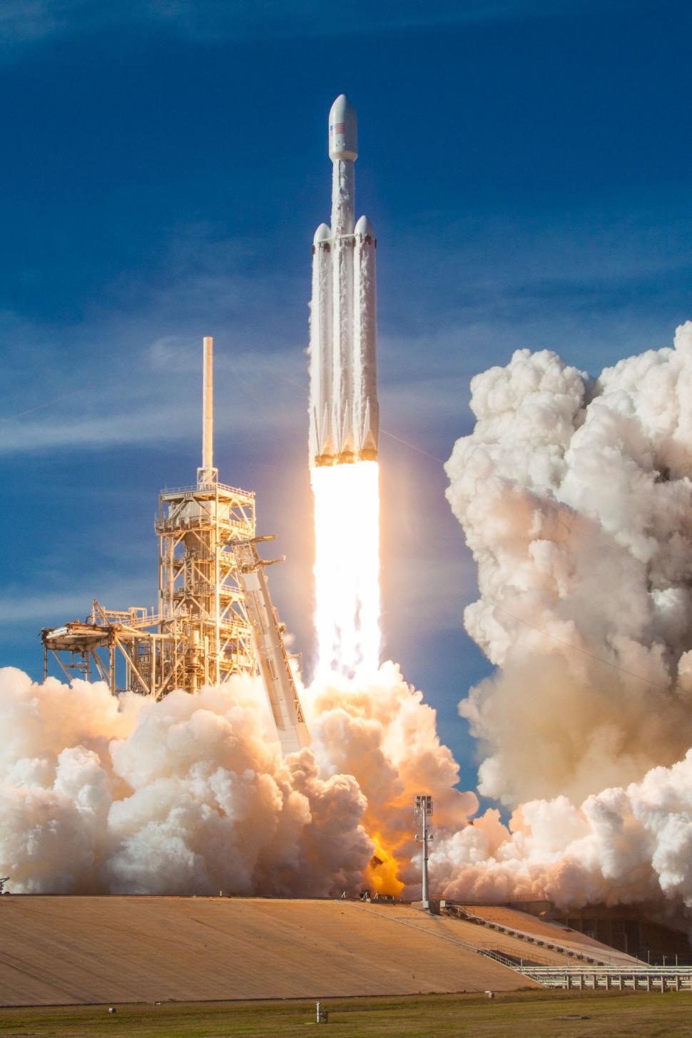 Free Image of Falcon Heavy rocket lift-off amidst clouds 