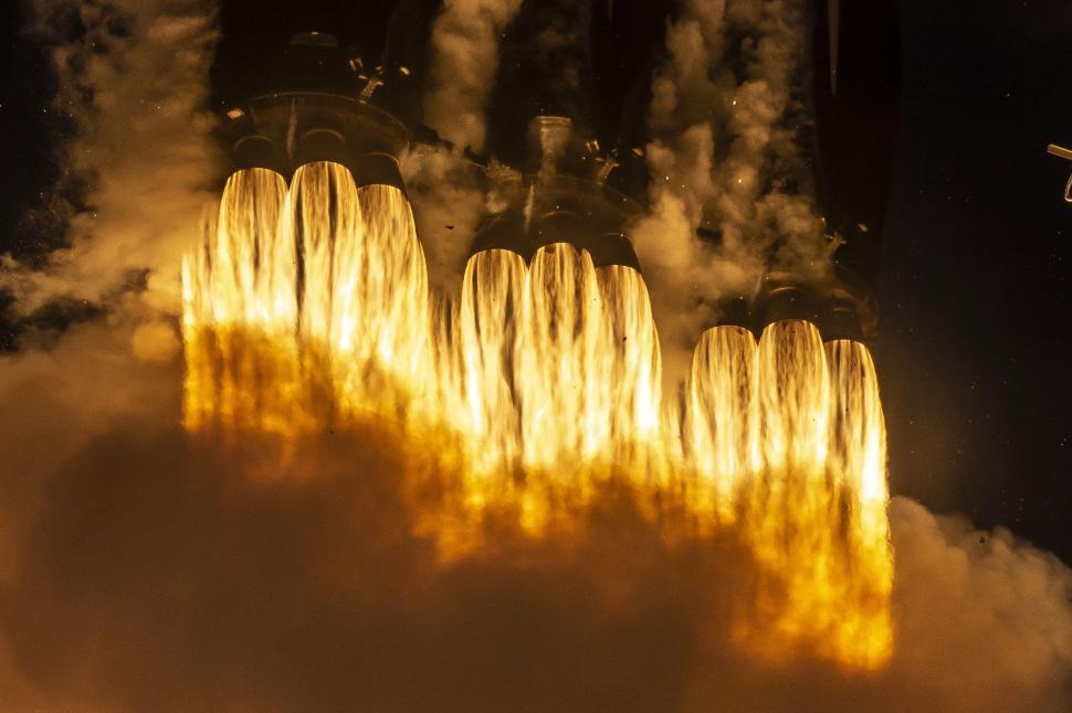 Free Image of Flaming rocket engines propelling a spacecraft at night 