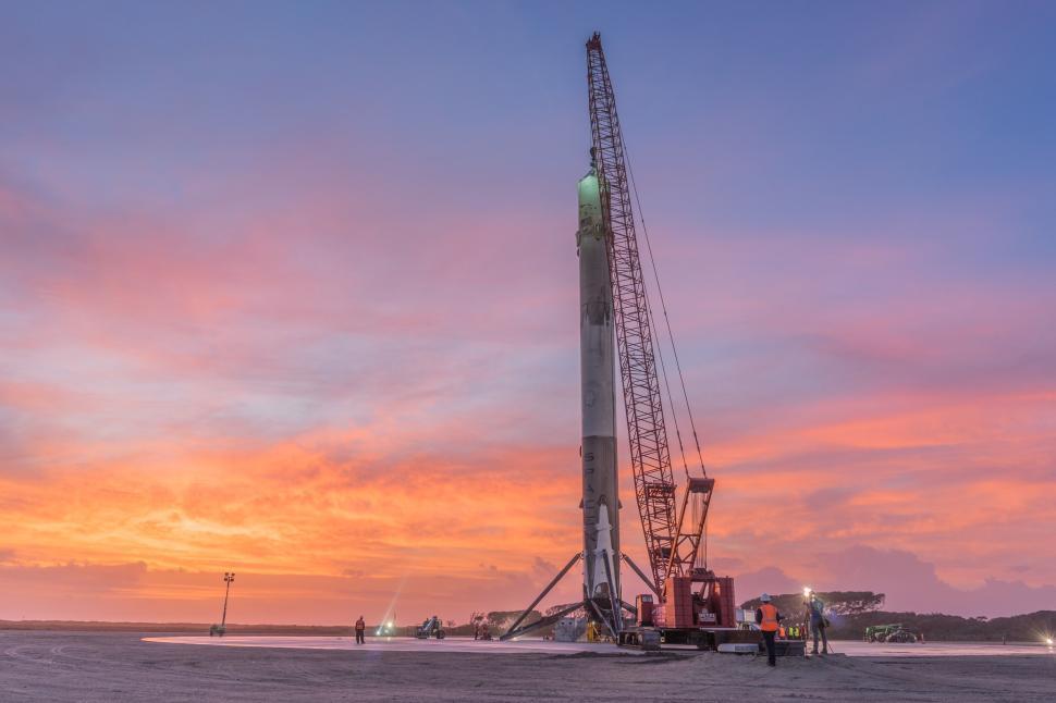 Free Image of Rocket positioned vertically during dawn with crew 