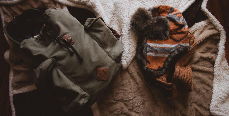 Free Image of Mountain gears set on cozy blanket ready for adventure. 