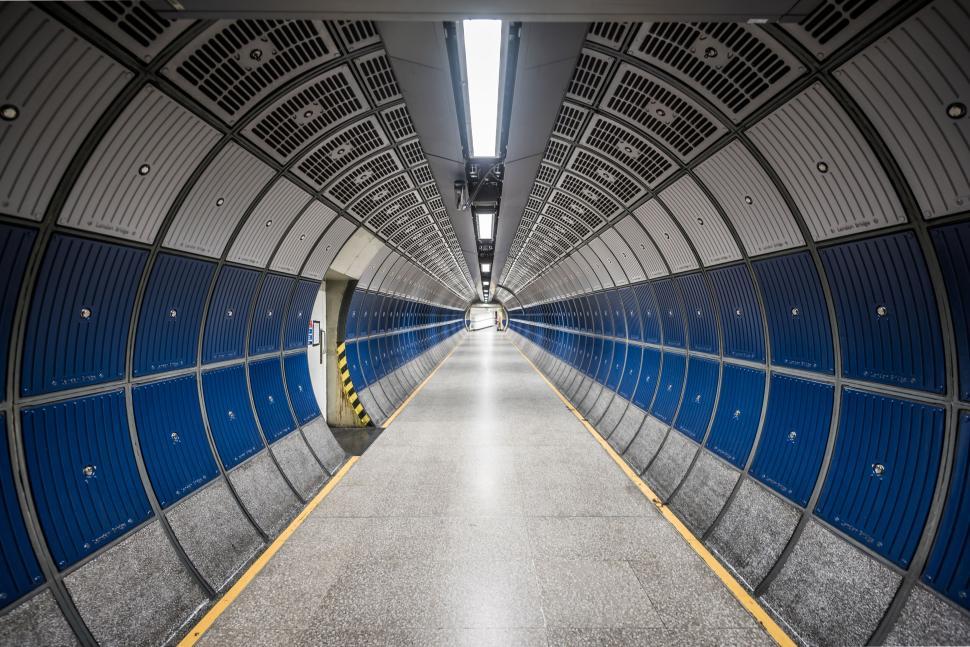 Free Image of Modern underground tunnel with vibrant blue panels. 