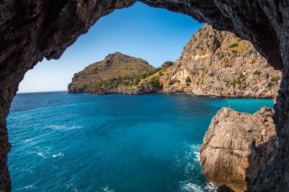 Free Image of Breathtaking cliffside view captured from a seaside cave 