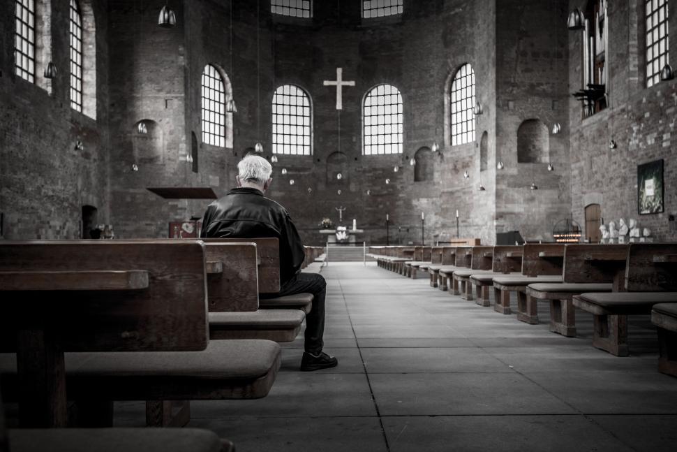Free Image of Solitary figure in a grand, historic church interior 