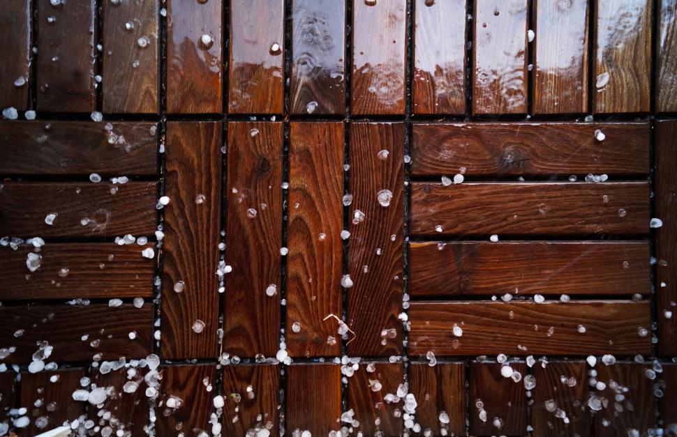Free Image of Raindrops scatter across wet wooden planks outdoors art. 