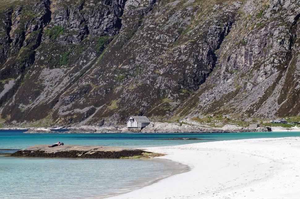 Free Image of Secluded cabin by majestic cliffs and turquoise water 