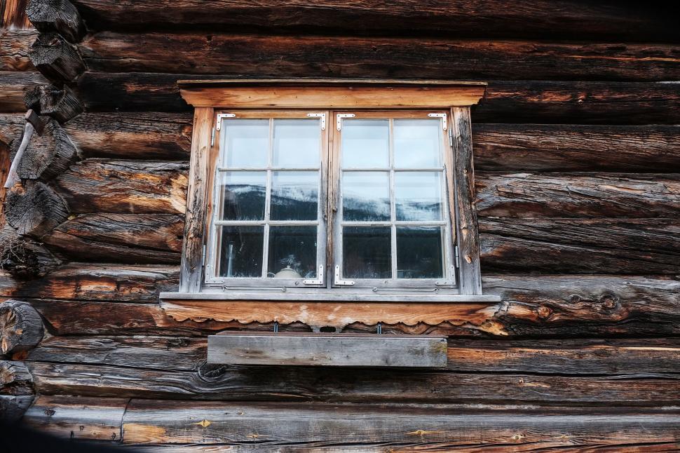 Free Image of Rustic wooden window on traditional log cabin exterior 
