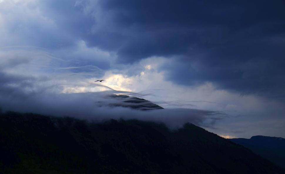 Free Image of Cloudy mountain scenery with dramatic dark skies 