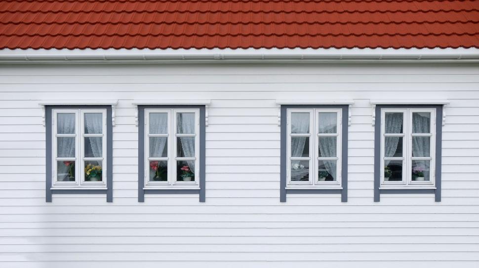 Free Image of Charming red-roofed house with four windows aligned 
