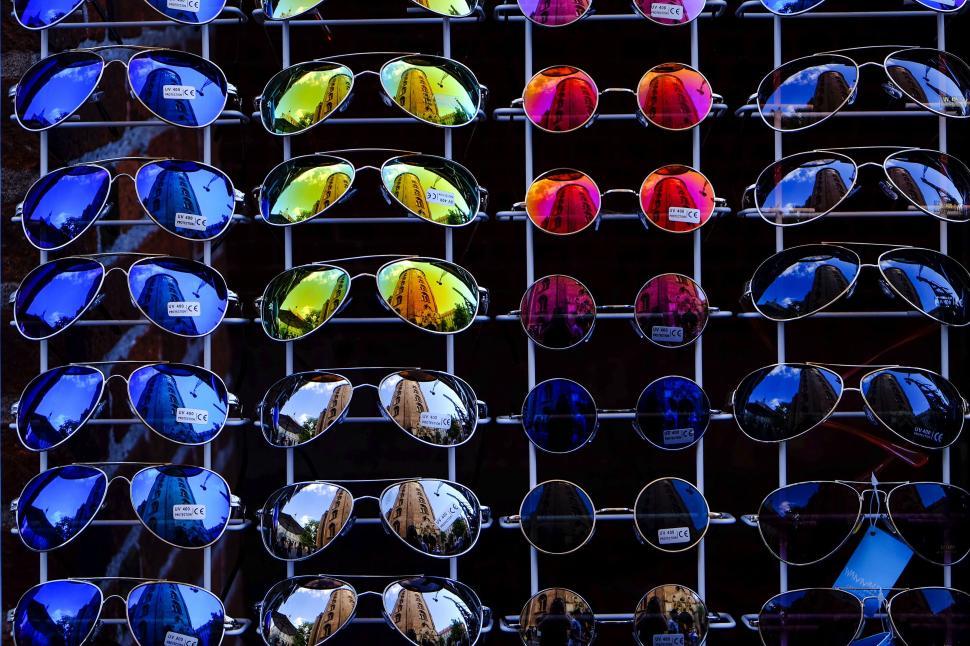 Free Image of Display of colorful sunglasses on market stand exterior. 