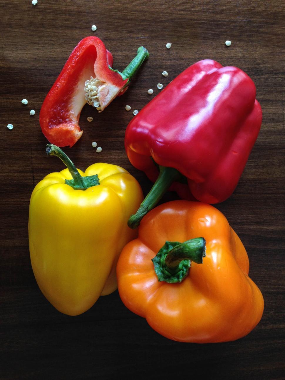 Free Image of Vibrant bell peppers in yellow, red, and orange arranged 